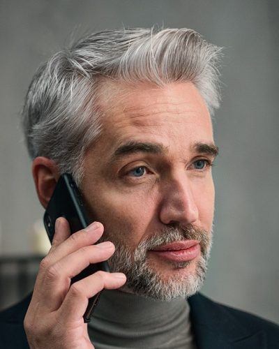 cropped-mature-businessman-making-a-phone-call-indoors-in-ZG7QWBJ.jpg